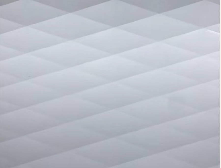 Close-up of embossed diamond pattern aluminum in white enamel